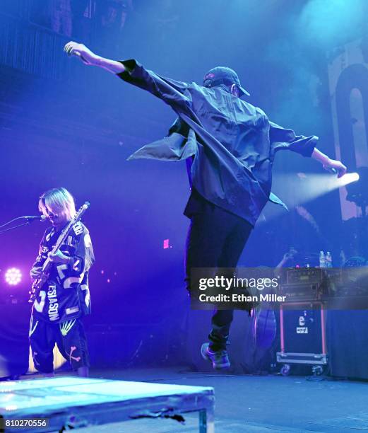 Bassist Ryota Kohama performs as singer Takahiro "Taka" Moriuchi of One OK Rock jumps off a riser as the band kicks off the Ambitions U.S. Tour 2017...
