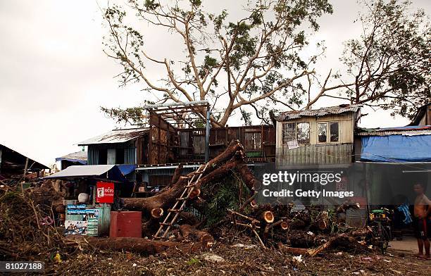 Man stands beside a house damaged by Cyclone Nargis on May 8 In Yangon, Myanmar. International Aid Agencies are continuing efforts to deliver aid...