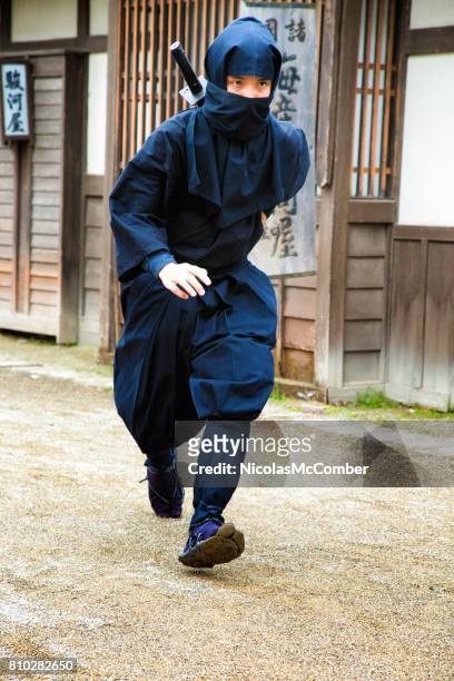 japanese ninja in black costume runs swiftly in old edo village - pounce attack stock pictures, royalty-free photos & images