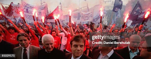 Serbia's nationalist prime minister and leader of the Democratic Party of Serbia - DSS Vojislav Kostunica arrives as volunteers hold flares during a...