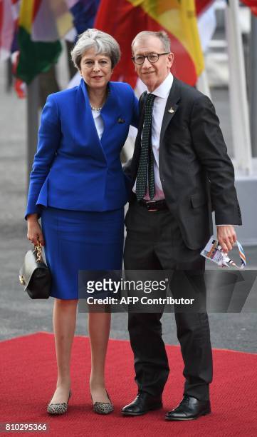 Britain's Prime Minister Theresa May and her husband Philip John May arrive for a concert at the Elbphilharmonie concert hall during the G20 Summit...