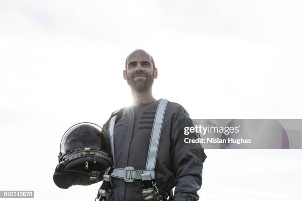 portrait of astronaut holding helmet - space helmet stock pictures, royalty-free photos & images