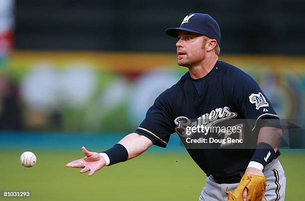 First baseman Joe Dillon of the Milwaukee Brewers tosses the ball to pitcher Carlos Villanueva to force out Jeremy Hermida of the Florida Marlins at...