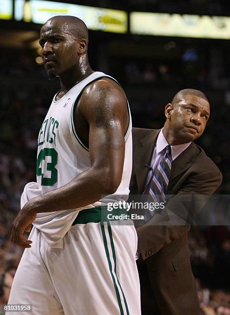 Kendrick Perkins of the Boston Celtics is consoled by head coach Doc Rivers after Perkins was pulled from the game with four fouls against the...