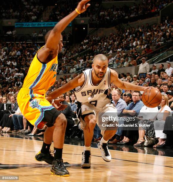 Tony Parker of the San Antonio Spurs drives against Chris Paul of the New Orleans Hornets in Game Three of the Western Conference Semifinals during...