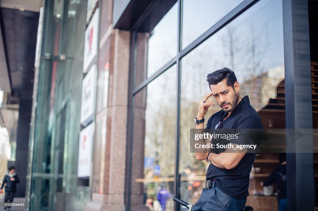 Young man standing on the city street