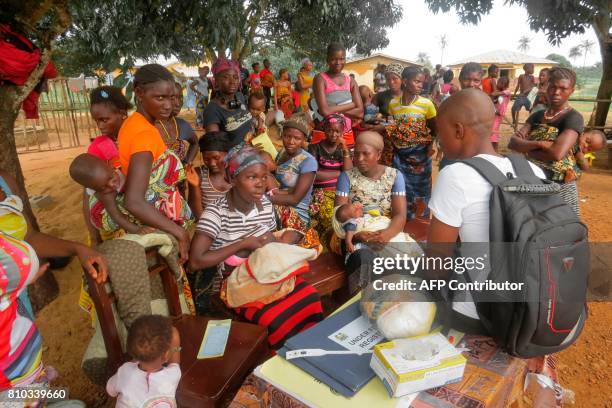 Sierra Leonian women gather during an outreach event at a maternity clinic on May 31, 2017 in Sembehun. Women from Sierra Leone can now pass on their...