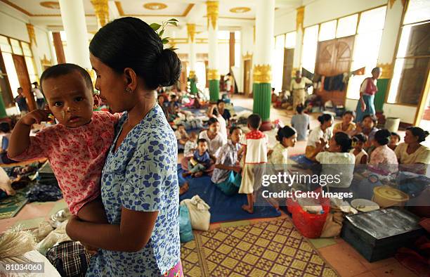 Burmese woman holds her child at refugee camp on on May 9 in Yangon, Myanmar. It has been estimated that more than 100,000 people were killed by...