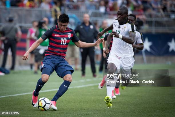 Joe Corona of U.S. Men's National Team stops the ball and keeps control against Issac Sackey of the Ghana National Team during the International...
