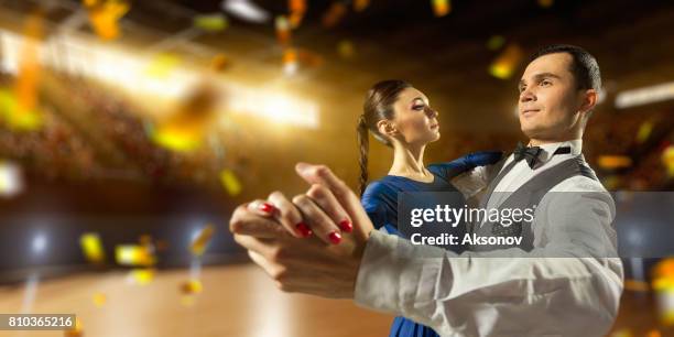 couple dancers ardently perform the latin american dance on a large professional stage with sparkle fireworks - rumba stock pictures, royalty-free photos & images