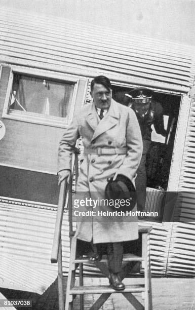 German Chancellor Adolf Hitler leaves an aircraft, circa 1935.