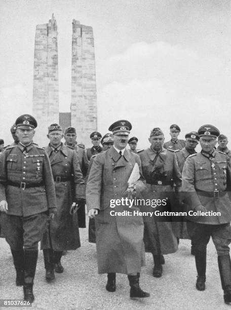 Nazi leader Adolf Hitler visits the First World War memorial to the Canadian soldiers killed at Vimy Ridge, France, circa 1940. With him is Wehrmacht...