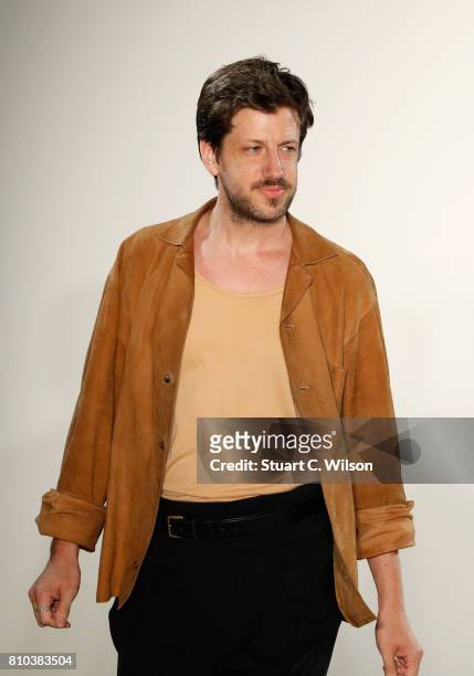 Designer Michael Sontag acknowledges the applause of the audience at the Michael Sontag show during the Mercedes-Benz Fashion Week Berlin...