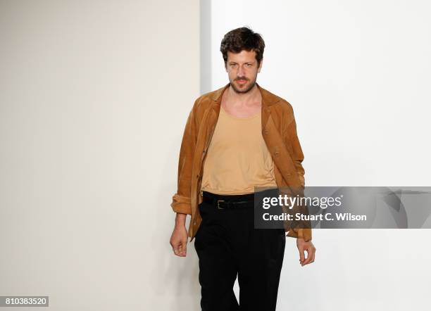 Designer Michael Sontag acknowledges the applause of the audience at the Michael Sontag show during the Mercedes-Benz Fashion Week Berlin...