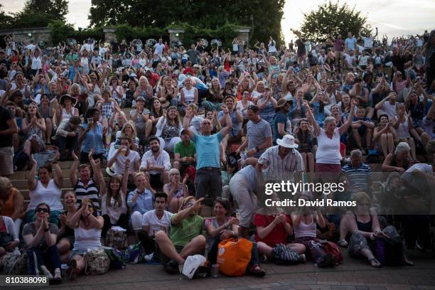 Spectators celebrate Andy Murray's victory over Fabio Fognini during their Gentlemen's Singles second round match from 'Murray Mound' on day five of...