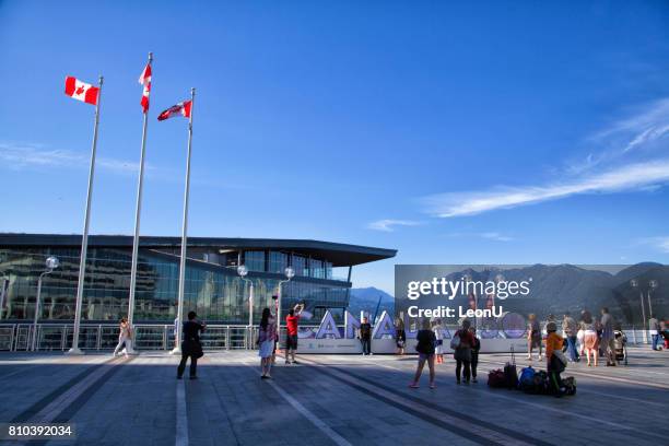 taking pictures in front of canada 150 sign,vancouver,canada - the blue man group in vancouver stock pictures, royalty-free photos & images