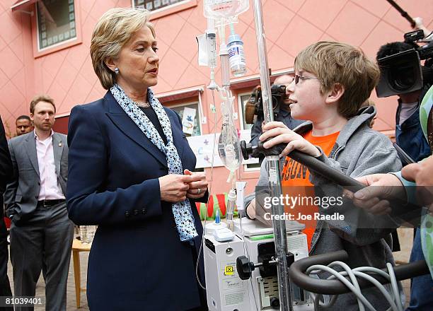 Democratic presidential hopeful U.S. Senator Hillary Clinton speaks to Logan Hockley, 11-years-old, who has cystic fybrosis and is on a IV pole and...