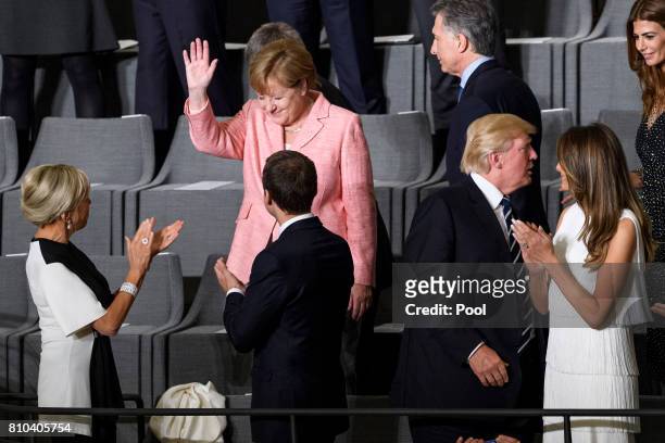 German Chancellor Angela Merkel attends a concert with French President Emmanuel Macron , his wife Brigitte Macron , US President Donald Trump , his...
