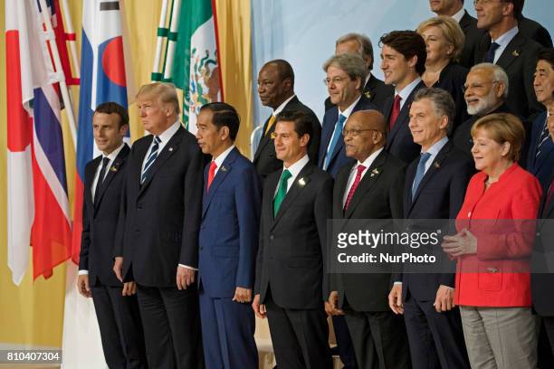 German Chancellor Angela Merkel poses for a family picture with other G20 summit leaders prior to a meeting at the Messe in Hambrug, Germany on July...