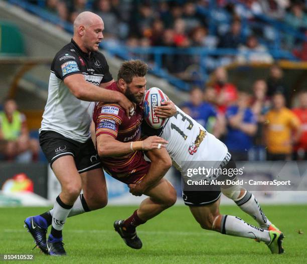 Huddersfield Giants's Shannon Wakeman is tackled by Widnes Vikings's Stefan Marsh and Hep Cahill during the Betfred Super League Round 21 match...