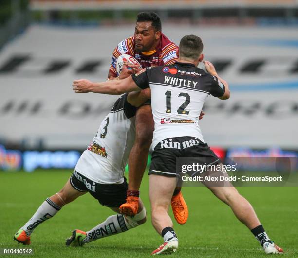 Huddersfield Giants's Ukuma Taai is tackled by Widnes Vikings's Matt Whitley and Hep Cahill during the Betfred Super League Round 21 match between...