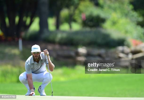 Graham DeLaet of Canada lines up his putt on the 15th green during round two of The Greenbrier Classic held at the Old White TPC on July 7, 2017 in...
