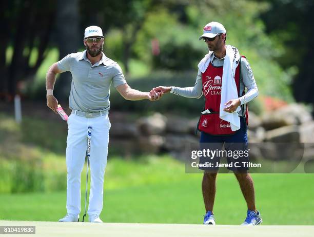 Graham DeLaet of Canada and his caddie stand on the 15th green during round two of The Greenbrier Classic held at the Old White TPC on July 7, 2017...