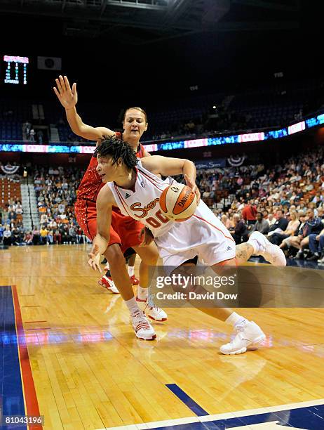 Tamika Whitmore of the Connecticut Sun drives past the Houston Comets during the WNBA game on May 9, 2008 at the Mohegan Sun Arena in Uncansville,...