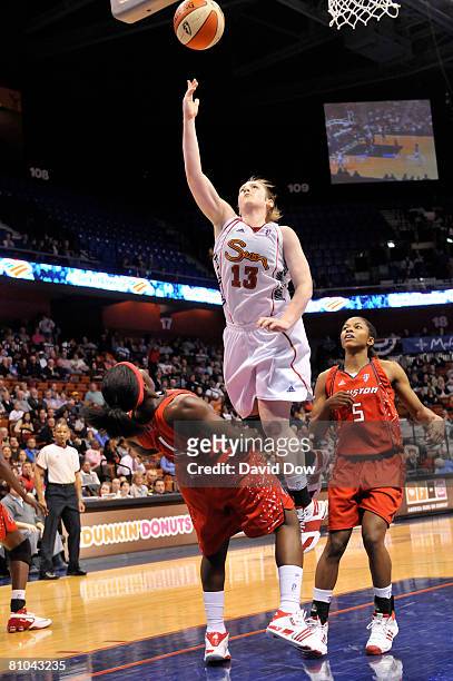 Lindsay Whalen of the Connecticut Sun shoots against Amber Holt of the Houston Comets during the WNBA game on May 9, 2008 at the Mohegan Sun Arena in...