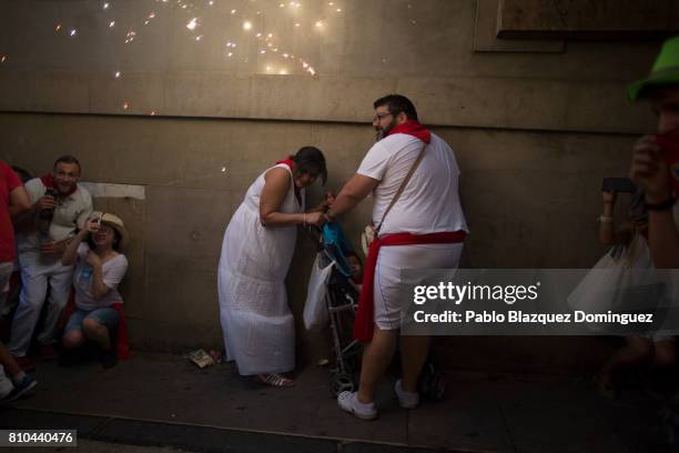 Revellers take cover as the Toro del Fuego is run through the streets of Pamplona during the second day of the San Fermin Running of the Bulls...
