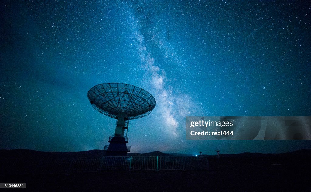 Satellite dish under a starry sky