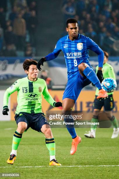 Jiangsu FC midfielder Liu Jianye fights for the ball with Jeonbuk Hyundai Motors midfielder Kim Bo Kyung during the AFC Champions League 2016 - Group...