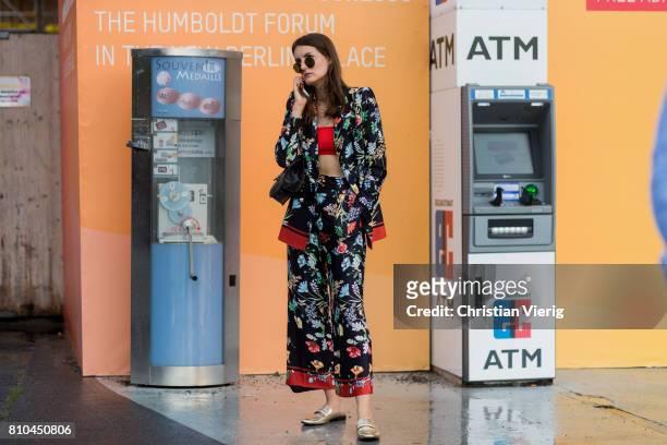 Guest wearing a silk suit with floral print, slippers outside Marina Hoermanseder during the Mercedes-Benz Fashion Week Berlin Spring/Summer 2018 on...
