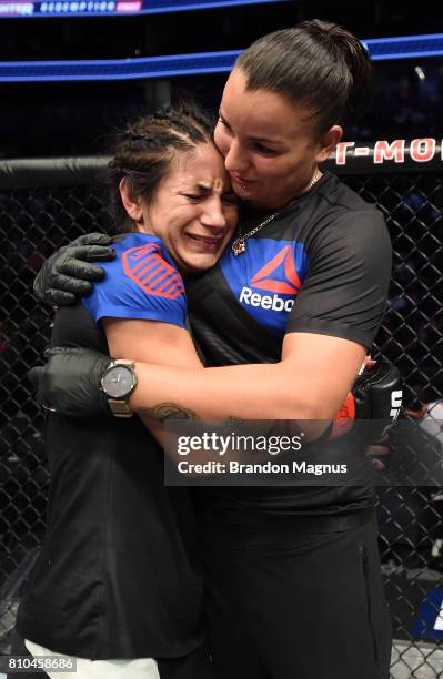 Tecia Torres celebrates with girlfiend and coach Raquel Pennington after her victory over Juliana Lima women's strawweight bout during The Ultimate...