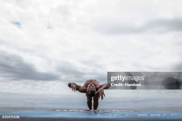 In this handout image provided by Red Bull, Artem Silchenko of Russia launches an armstand dive from the 27 metre platform on Islet Franca do Campo...