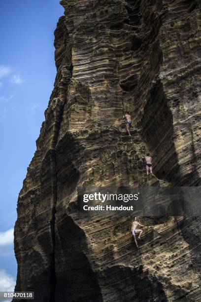 In this handout image provided by Red Bull, Kyle Mitrione, Andy Jones and David Colturi of the USA climb the monolith next to Islet Franca do Campo...