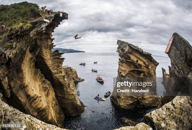 In this handout image provided by Red Bull, Andy Jones of the USA dives 25.5 metres from the Snakehead on Islet Franca do Campo during the first...