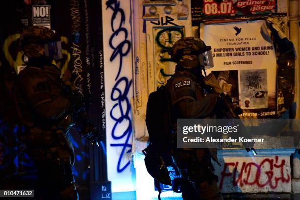 Members of a SWAT team observe an apartment used by protesters during an anti-G20 protest on July 7, 2017 in Hamburg, Germany. Authorities are braced...