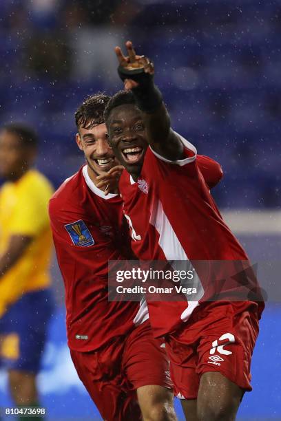 Alphonso Davies of Canada celebrates with teammates after scoring the fourth goal of his team during the Group A match between French Guiana and...