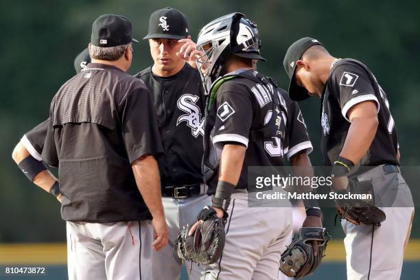 Pitching coach Don Cooper confers with starting pitcher Derek Holland of the Chicago White Sox in the first inning against the Colorado Rockies at...