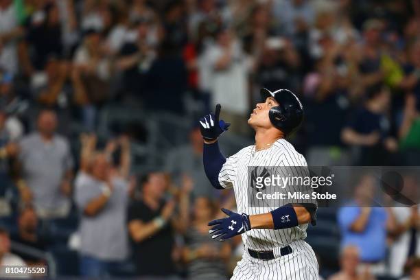 Aaron Judge of the New York Yankees points to the sky after connecting on a solo home run in the fifth inning against the Milwaukee Brewers at Yankee...