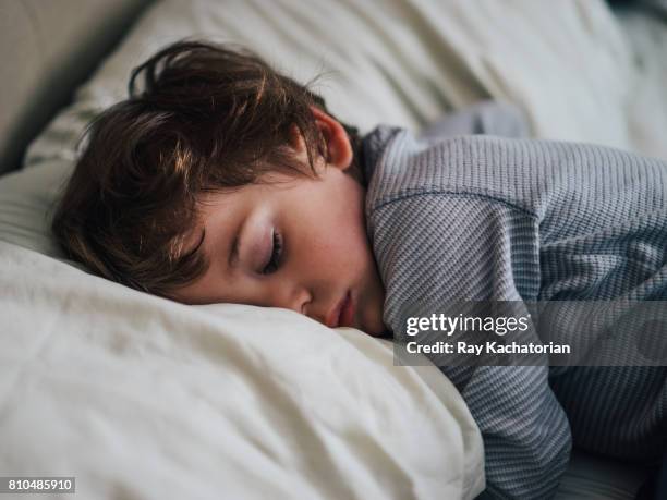 toddler sleeping on pillow - boy asleep in bed stock pictures, royalty-free photos & images