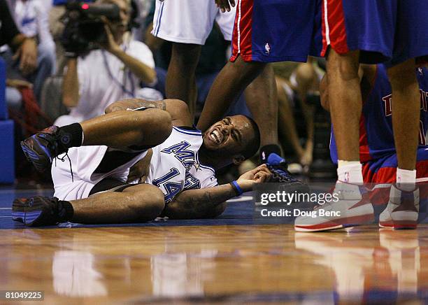 Jameer Nelson of the Orlando Magic grimaces in pain after battling for the ball with Lindsey Hunter of the Detroit Pistons in Game Four of the...