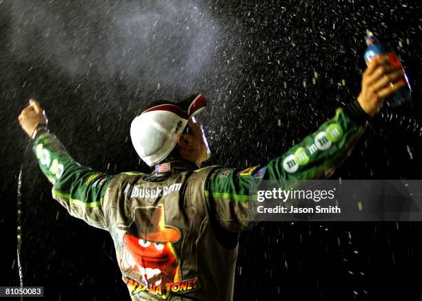 Kyle Busch, driver of the M&M's Indiana Jones Toyota, celebrates in victory lane after winning the NASCAR Sprint Cup Series Dodge Challenger 500 on...