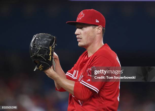 Lucas Harrell of the Toronto Blue Jays looks in before delivering a pitch in the seventh inning during MLB game action against the Boston Red Sox at...