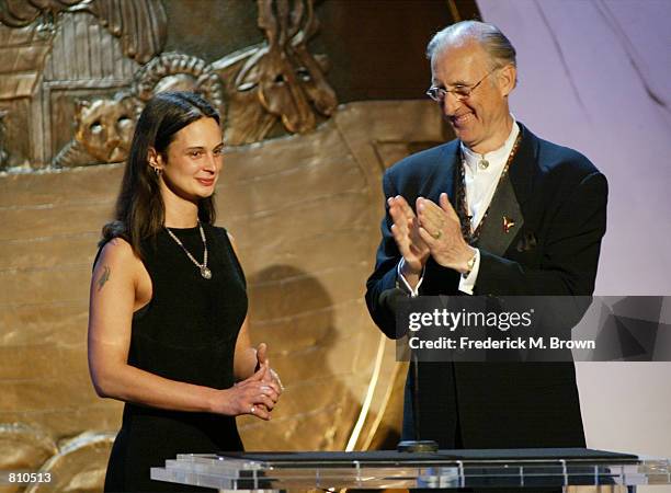 Actor James Cromwell claps as Environmentalist Julia Butterfly Hill looks on during the 16th Annual Genesis Awards at The Beverly Hilton Hotel March...