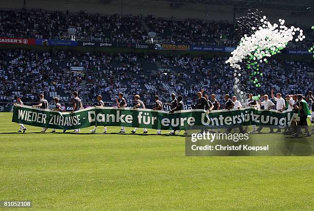 The team of Gladbach celebrates the climb to the Bundesliga with a banner before the Second Bundesliga match between Borussia Moenchengladbach and SC...