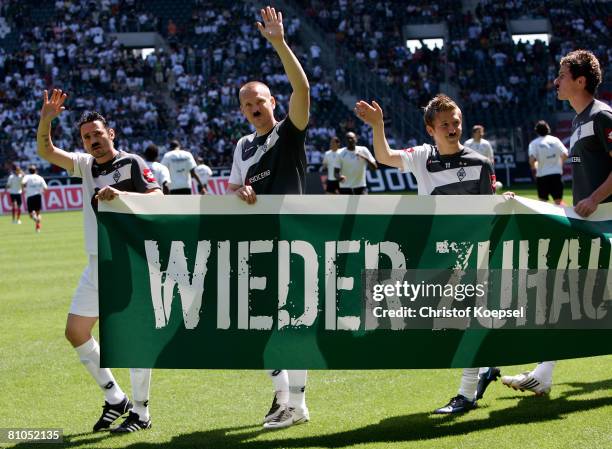 Oliver Neuville, Sascha Roesler and Marko Marin of Gladbach celebrate the climb to the Bundesliga before the Second Bundesliga match between Borussia...