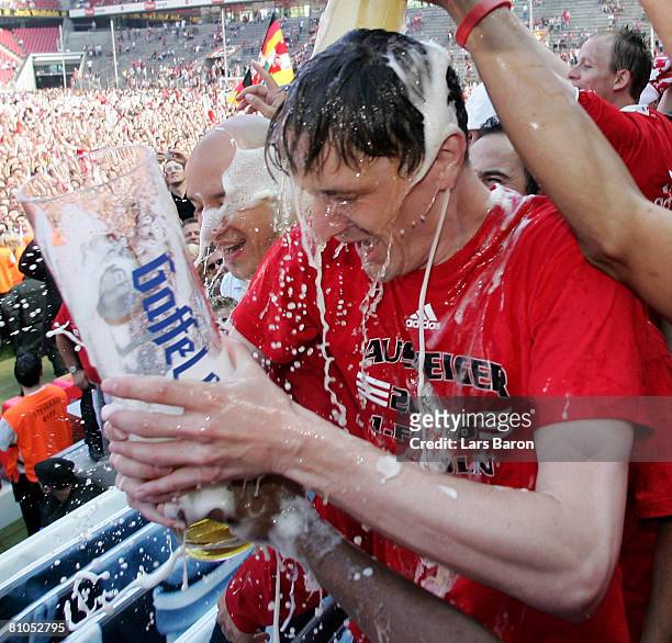 Milivoje Novakovic of Koeln gets a bear shower after winning the Second Bundesliga match between 1. FC Koeln and FSV Mainz 05 at the RheinEnergie...