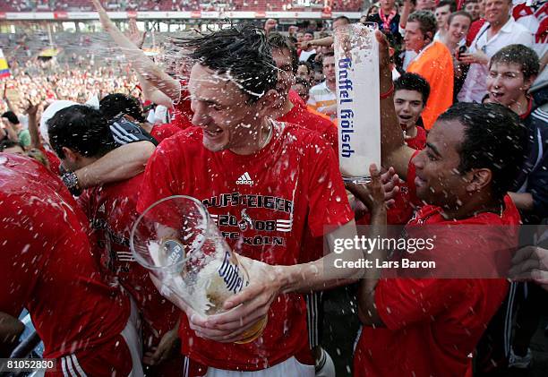 Milivoje Novakovic of Koeln gets a bear shower after winning the Second Bundesliga match between 1. FC Koeln and FSV Mainz 05 at the RheinEnergie...